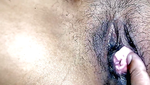 Indian teen with a hairy pussy is sliding toy on her pussy