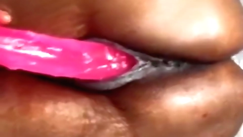 A teen is getting fucked by a big dildo in her pussy