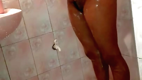 Chubby brunette with a big booty fucks herself in the shower