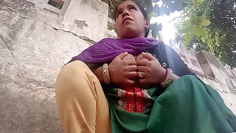 Indian brunette pokes her ass with her fingers in the rain