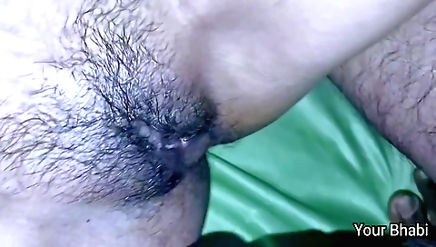 Indian woman in a red dress and a pink blouse is standing and sitting