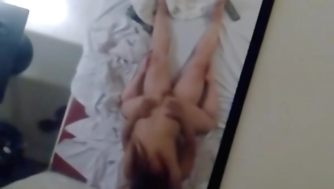 Amateur video of a brunette with huge tits taking off a dress