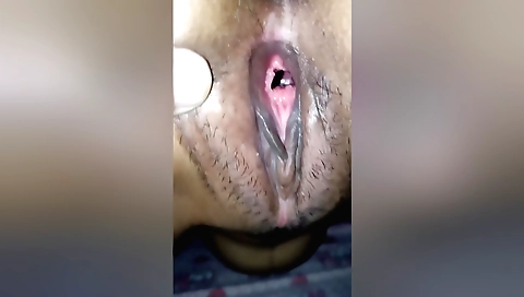 A hairy girl is getting her pussy filled with a man's cock