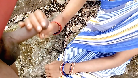 Handjob for an Indian teen on his back in the park